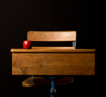 An apple on a school desk